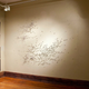 Illustration for article titled Mysterious, tiny human figures march across a wall